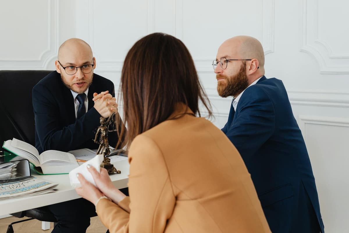 Avocat en consultation avec client, documents juridiques sur la table